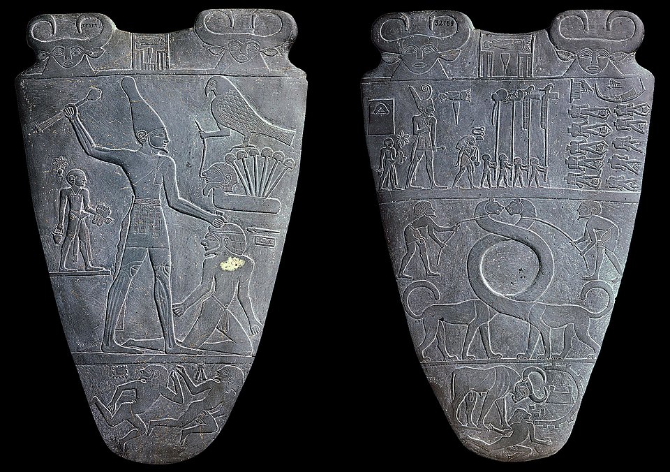 Image of stone tablets known as palettes with engraved images of Pharaoh in scenes of violence.